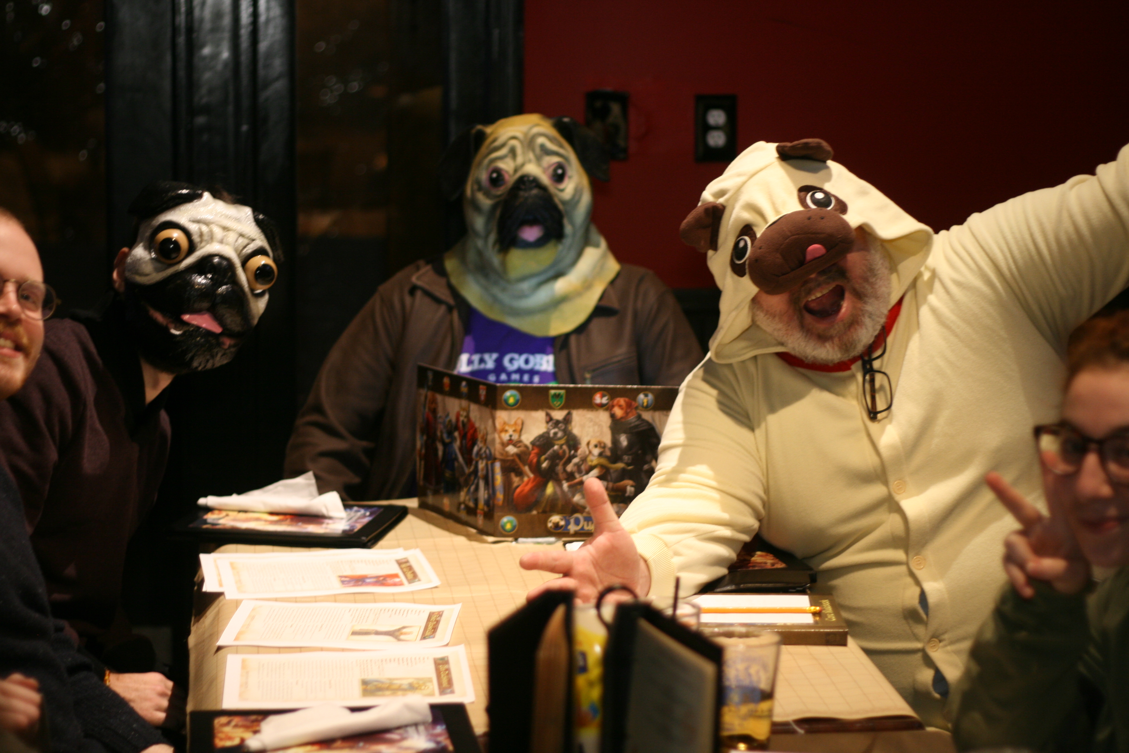 Lex and fellow players wearing pug costumes and masks during a Pugmire game at The Chromatic Dragon